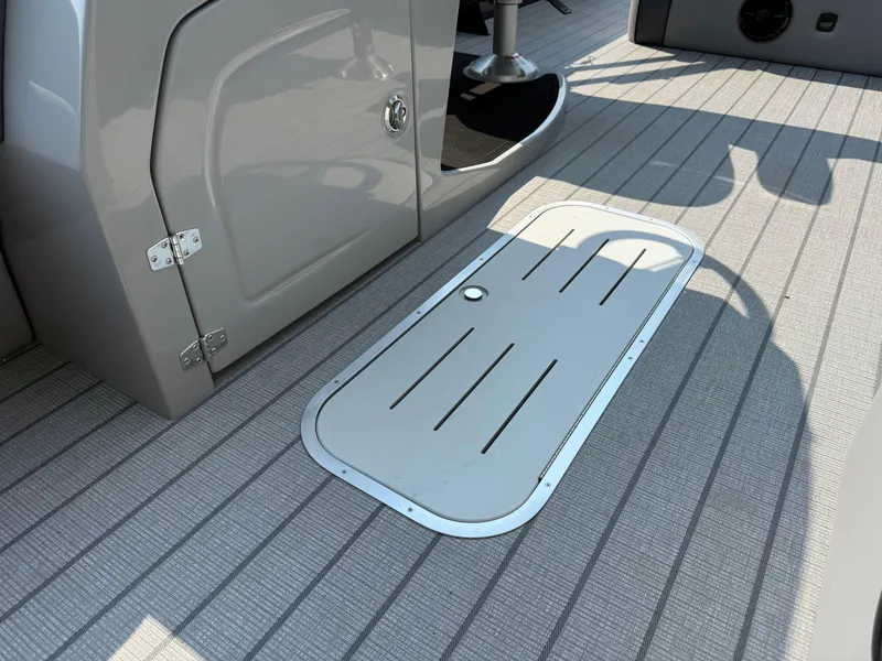 Slide: The Image of 2026 Bentley Pontoons Elite 223 Swingback Dual Capt. deck with sleek design and storage compartment. - 10