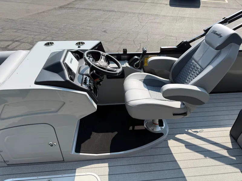 Slide: The Image of 2026 Bentley Pontoons Elite 223 Swingback Dual Capt. helm with luxurious captain's chair and controls. - 12