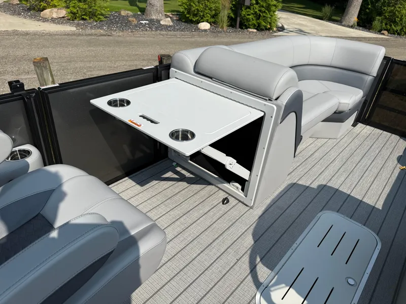 Slide: The Image of 2026 Bentley Pontoons Elite 223 interior with swingback seating and foldable table. - 23