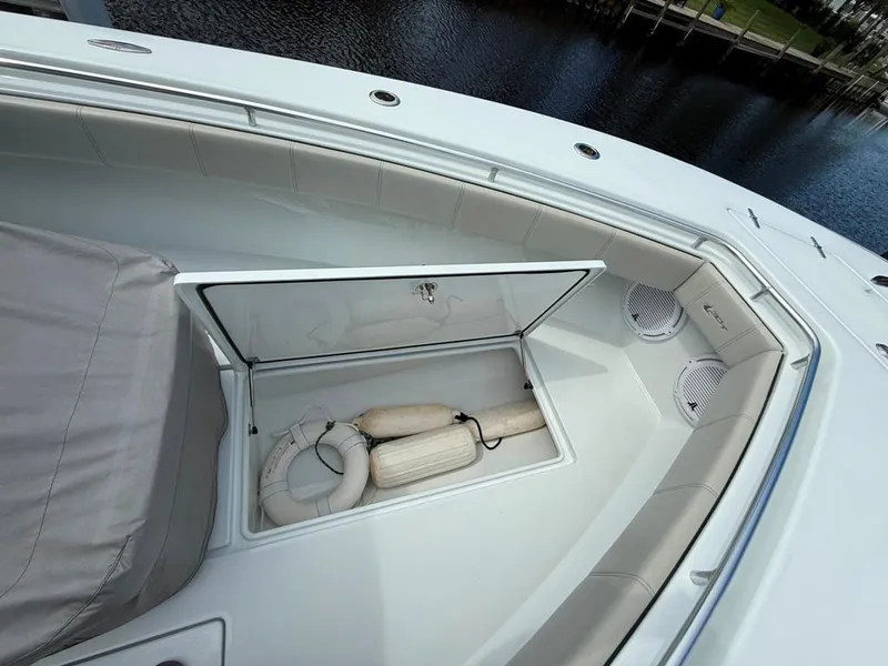 Slide: The Image of 2023 Contender 30 Tournament boat with open storage compartment and life-saving equipment. - 13