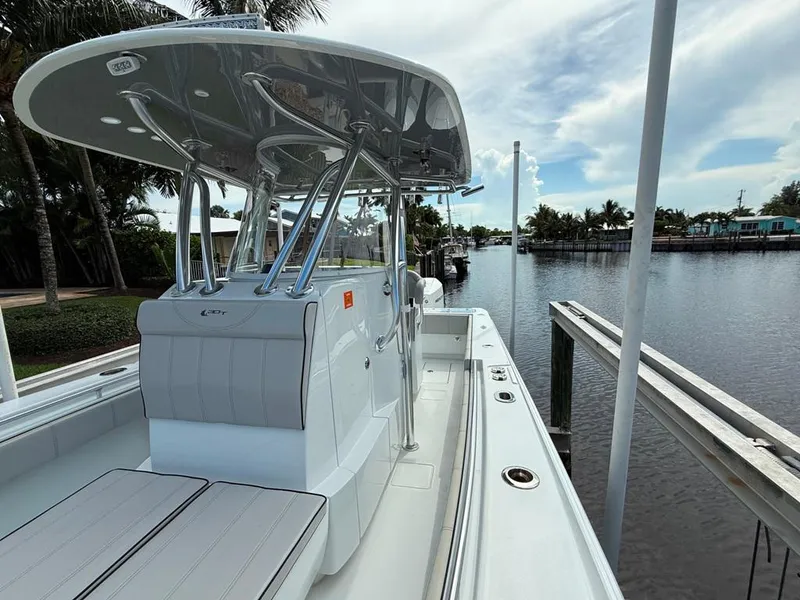 Slide: The Image of 2023 Contender 30 Tournament boat docked by a scenic waterfront. - 17