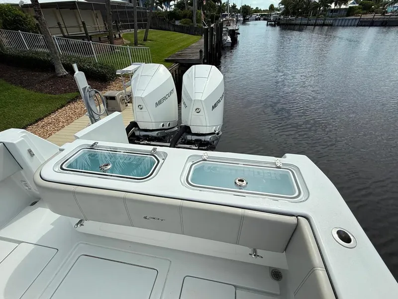 Slide: The Image of 2023 Contender 30 Tournament boat with dual Mercury engines on a calm canal. - 20