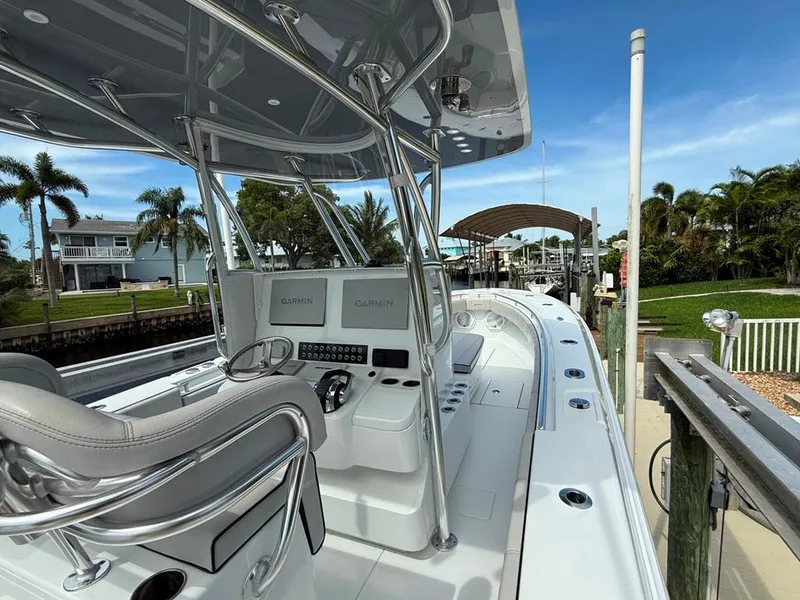 Slide: The Image of 2023 Contender 30 Tournament boat with modern helm, docked near waterfront homes. - 21