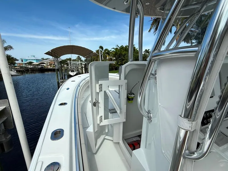 Slide: The Image of 2023 Contender 30 Tournament boat docked by waterfront with clear blue sky. - 23