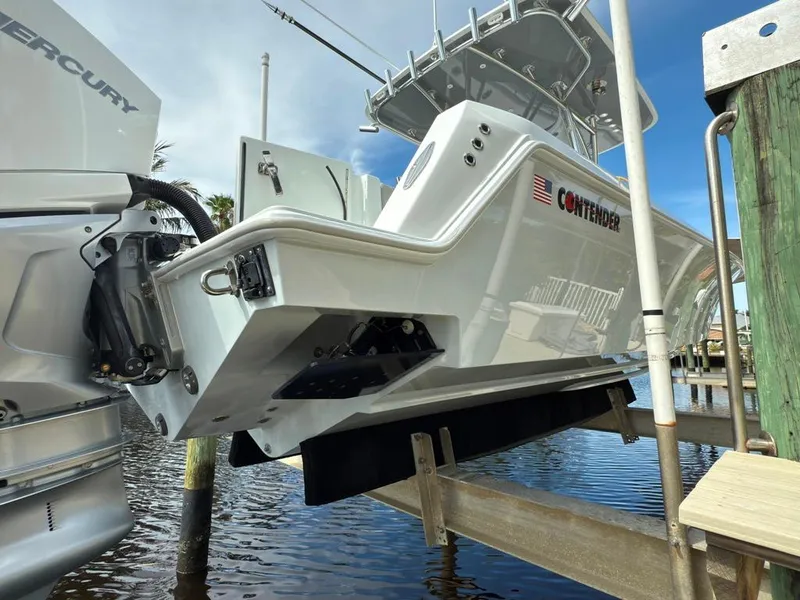 Slide: The Image of 2023 Contender 30 Tournament boat on lift, featuring sleek design and Mercury engine. - 30