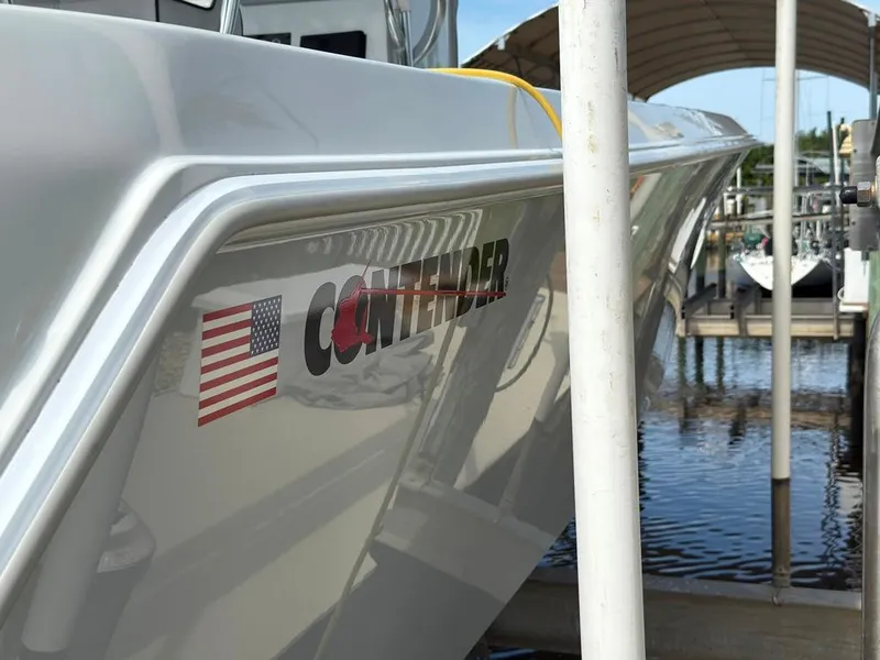 Slide: The Image of 2023 Contender 30 Tournament boat docked, featuring American flag decal. - 31