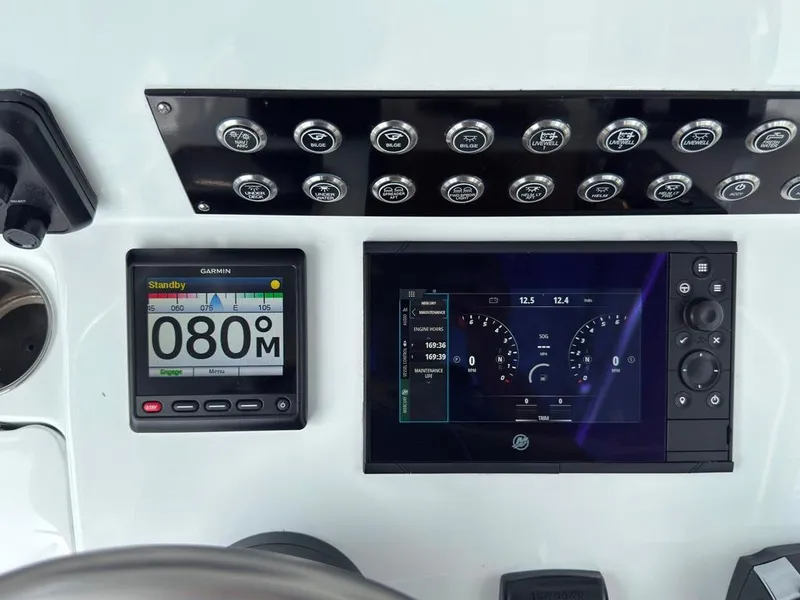 Slide: The Image of Dashboard of 2023 Contender 30 Tournament boat with Garmin navigation and control panel. - 36