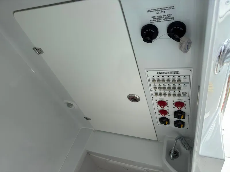 Slide: The Image of Control panel of 2023 Contender 30 Tournament boat with switches and labels. - 37