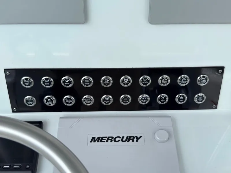 Slide: The Image of Control panel of 2023 Contender 30 Tournament boat with labeled buttons and Mercury branding. - 43