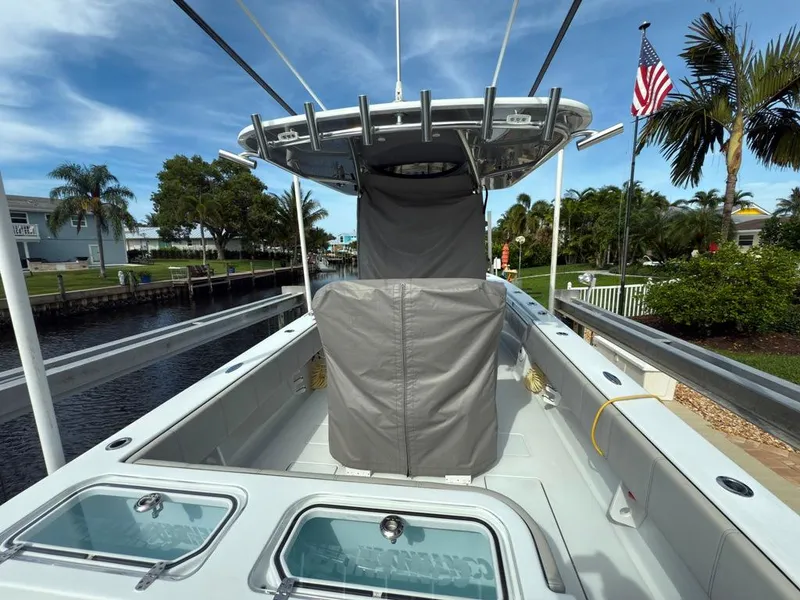 Slide: The Image of 2023 Contender 30 Tournament boat docked, featuring covered seating and fishing rod holders. - 44
