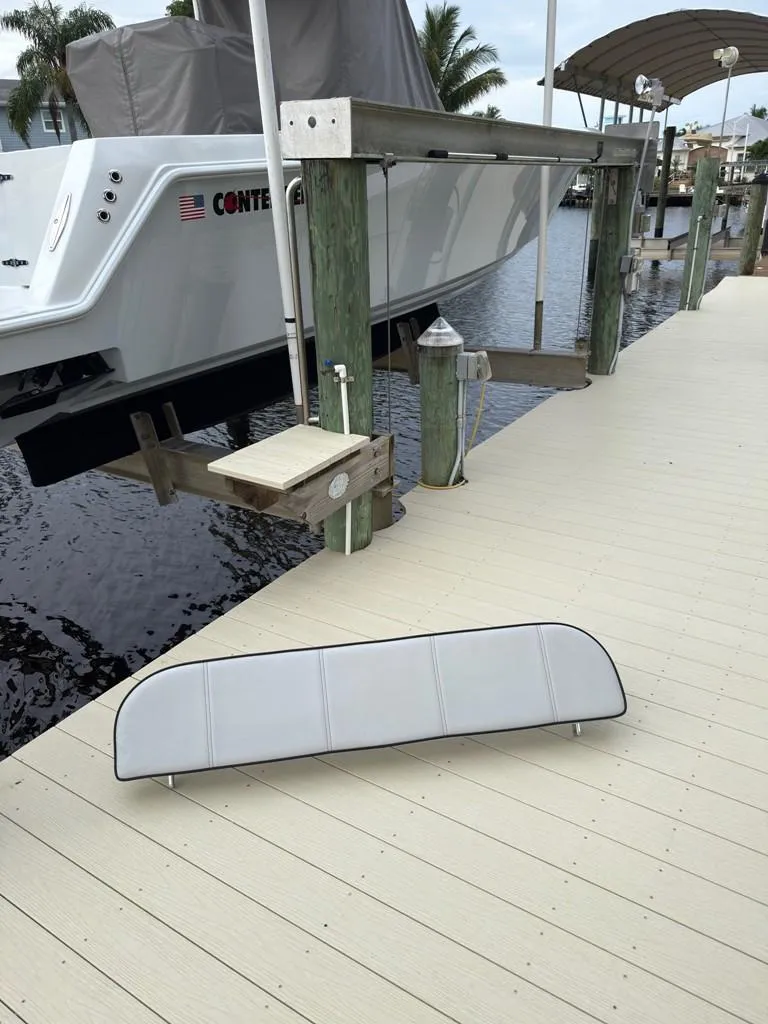 Slide: The Image of 2023 Contender 30 Tournament boat docked, with a cushion on the pier. - 45