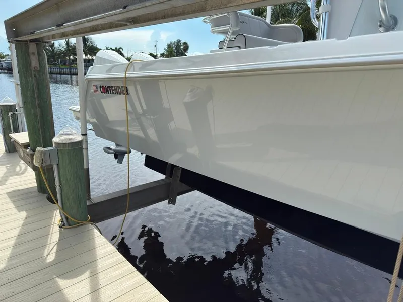 Slide: The Image of 2023 Contender 30 Tournament boat docked on a sunny day. - 8