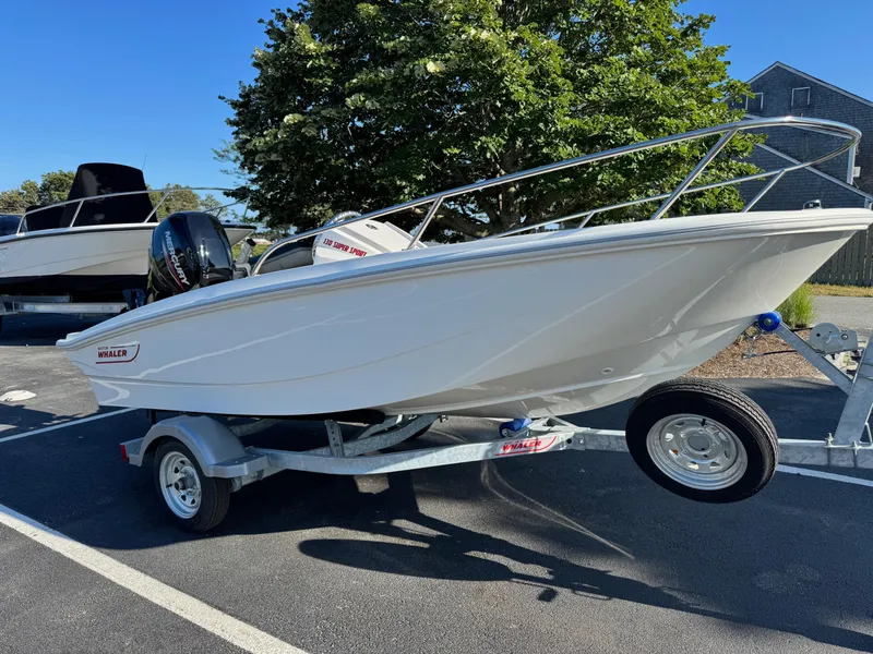 Slide: The Image of 2025 Boston Whaler 130 Super Sport boat on trailer, parked outdoors. - 3