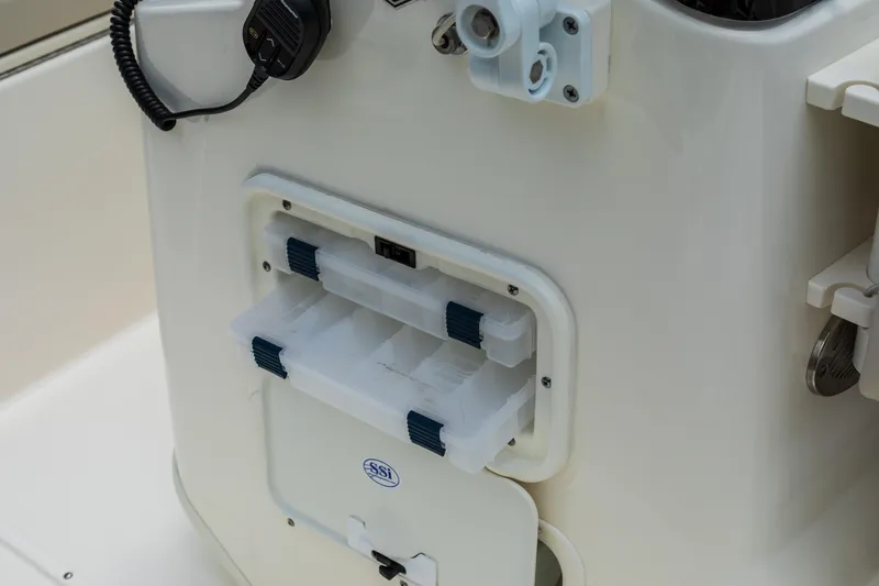 Slide: The Image of 2025 Boston Whaler 170 Montauk boat console with storage compartments and radio. - 11