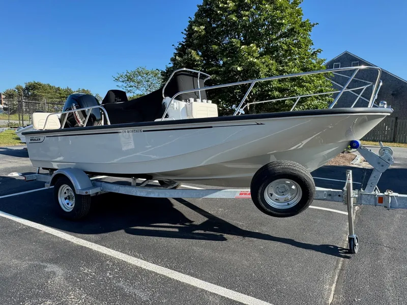 Slide: The Image of 2025 Boston Whaler 170 Montauk boat on trailer in parking lot. - 3