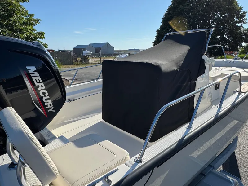 Slide: The Image of 2025 Boston Whaler 170 Montauk boat with Mercury engine, covered console, and seating. - 5