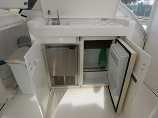 Slide: The Image of 2000 Tiara Yachts 5200 Express interior with open cabinets and sink. - 17