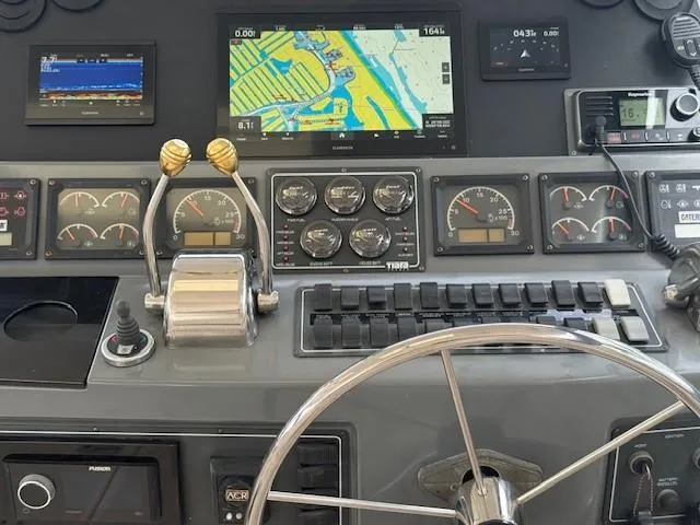 Slide: The Image of Control panel of a 2000 Tiara Yachts 5200 Express with navigation and engine gauges. - 19