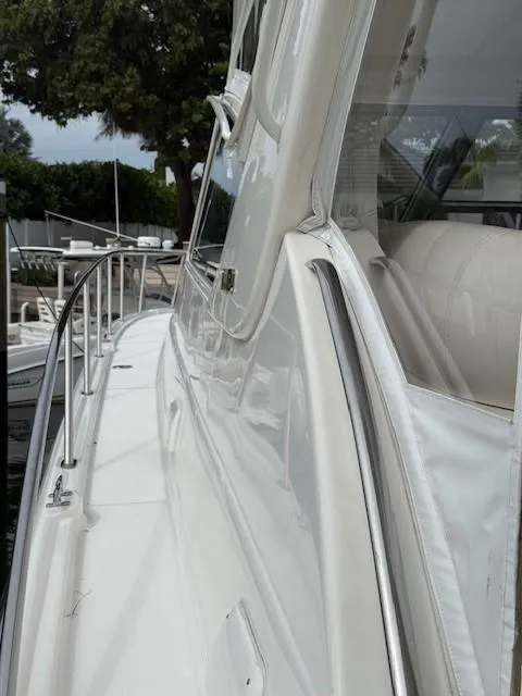 Slide: The Image of Side view of a 2000 Tiara Yachts 5200 Express, showcasing sleek design and railing. - 22