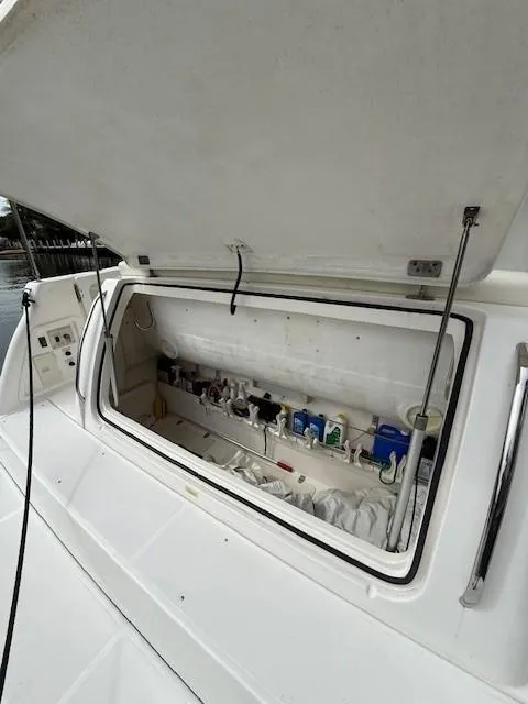 Slide: The Image of Open storage compartment on a 2000 Tiara Yachts 5200 Express boat. - 24