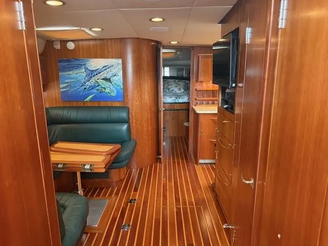 Slide: The Image of Interior of 2000 Tiara Yachts 5200 Express with wood paneling and seating area. - 33