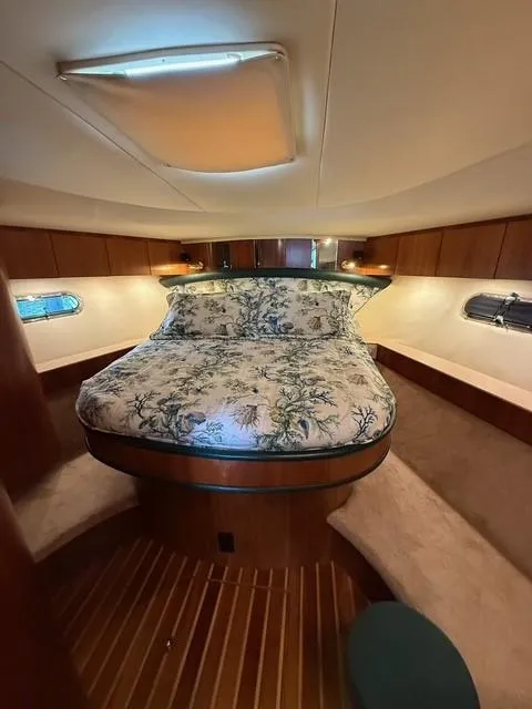 Slide: The Image of Luxurious cabin interior of 2000 Tiara Yachts 5200 Express with elegant bedding and wood finishes. - 37