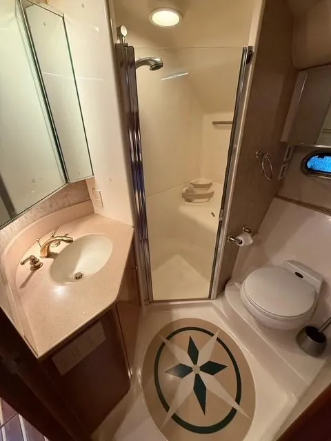 Slide: The Image of Bathroom interior of 2000 Tiara Yachts 5200 Express with shower, sink, and toilet. - 38
