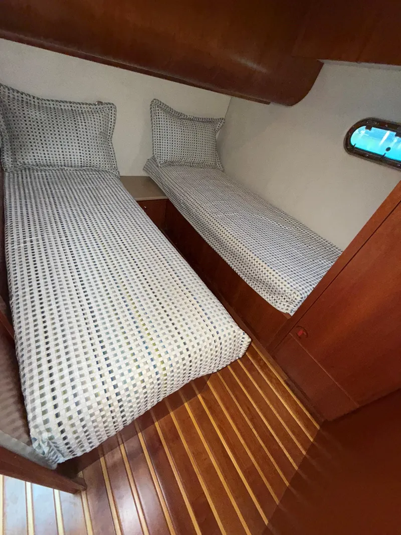 Slide: The Image of Twin beds in 2000 Tiara Yachts 5200 Express cabin with wooden flooring. - 39