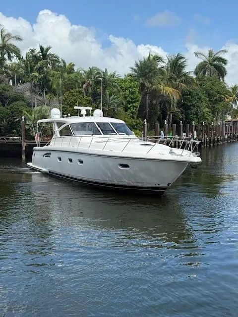Slide: The Image of 2000 Tiara Yachts 5200 Express cruising on a tropical waterway with palm trees. - 4