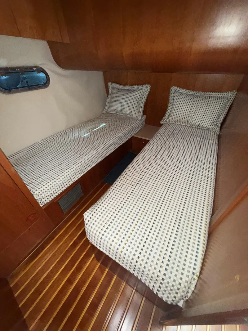 Slide: The Image of Twin beds in the cabin of a 2000 Tiara Yachts 5200 Express. - 40