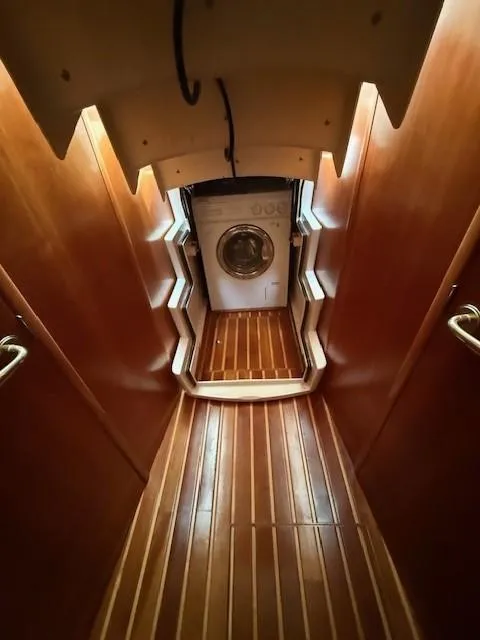 Slide: The Image of Interior of 2000 Tiara Yachts 5200 Express with wooden flooring and washing machine. - 42
