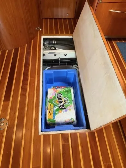 Slide: The Image of Storage compartment on 2000 Tiara Yachts 5200 Express with paper towels and equipment. - 43