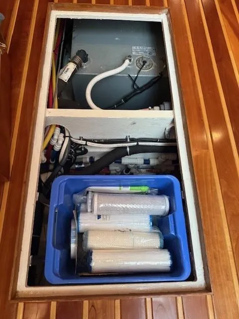 Slide: The Image of Engine compartment of 2000 Tiara Yachts 5200 Express with filters and components. - 44