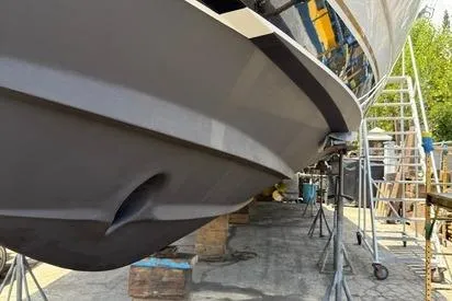 Slide: The Image of 2000 Tiara Yachts 5200 Express on dry dock, hull view with maintenance equipment. - 57
