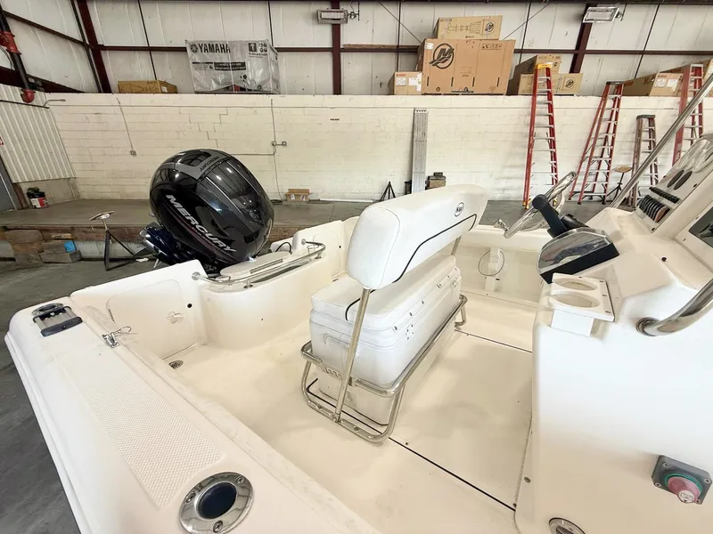 Slide: The Image of 2013 Key West 186CC boat interior with Mercury engine in a warehouse setting. - 5