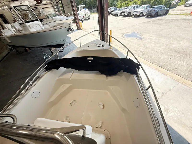 Slide: The Image of 2013 Key West 186CC boat in a garage, surrounded by other vehicles. - 7