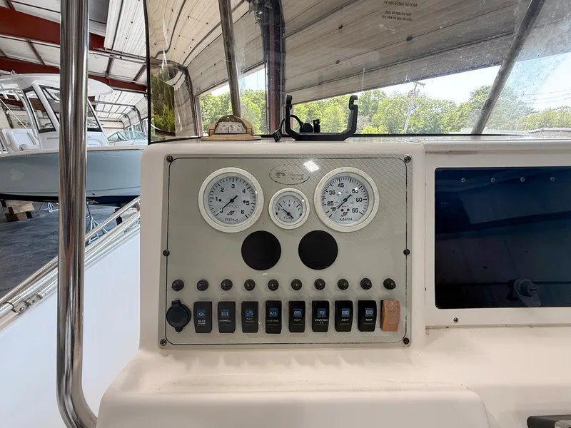 Slide: The Image of Control panel of a 2013 Key West 186CC boat with gauges and switches. - 9