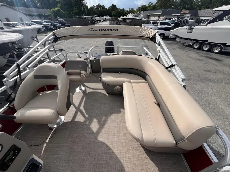 Slide: The Image of 2023 Sun Tracker Bass Buggy 18 DLX pontoon boat with beige seating and canopy. - 10