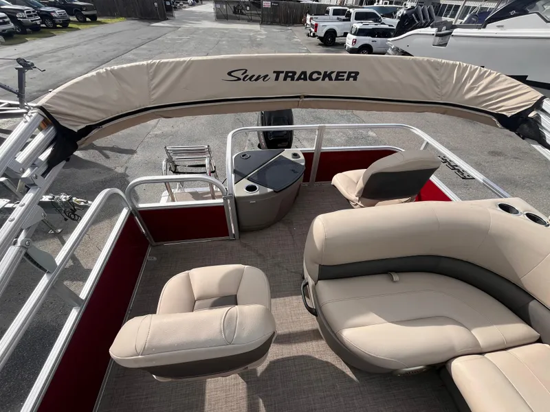 Slide: The Image of 2023 Sun Tracker Bass Buggy 18 DLX pontoon boat with beige seating and canopy. - 12