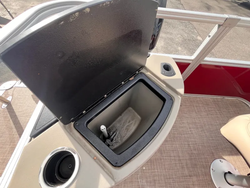 Slide: The Image of 2023 Sun Tracker Bass Buggy 18 DLX boat with open storage compartment and cup holder. - 14