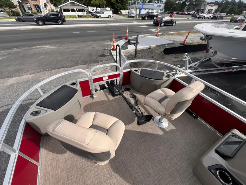 Slide: The Image of 2023 Sun Tracker Bass Buggy 18 DLX pontoon boat interior with seating and controls. - 6