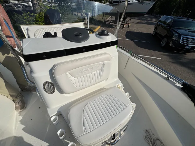 Slide: The Image of 2011 Boston Whaler 180 Dauntless boat interior with white seating and console. - 11