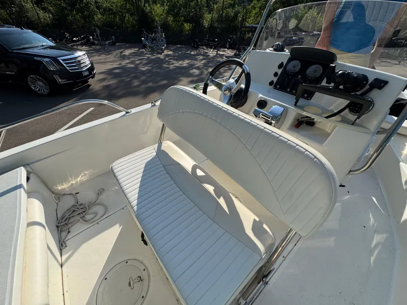 Slide: The Image of 2011 Boston Whaler 180 Dauntless boat interior with steering console and seating. - 18