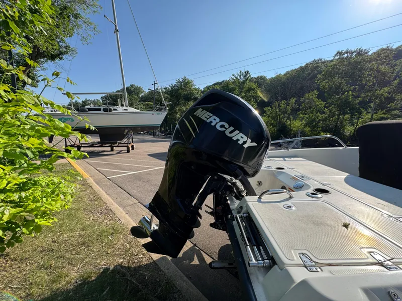 Slide: The Image of 2011 Boston Whaler 180 Dauntless with Mercury outboard motor in a sunny parking lot. - 4