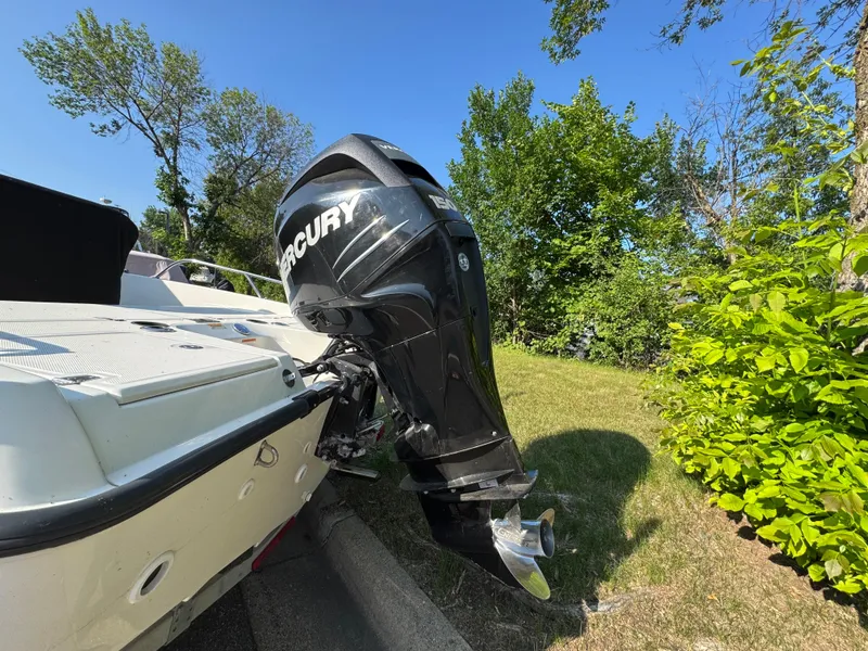 Slide: The Image of 2011 Boston Whaler 180 Dauntless with Mercury outboard motor, parked on grass. - 5