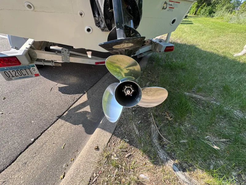 Slide: The Image of Propeller of a 2011 Boston Whaler 180 Dauntless on a trailer, parked roadside. - 6