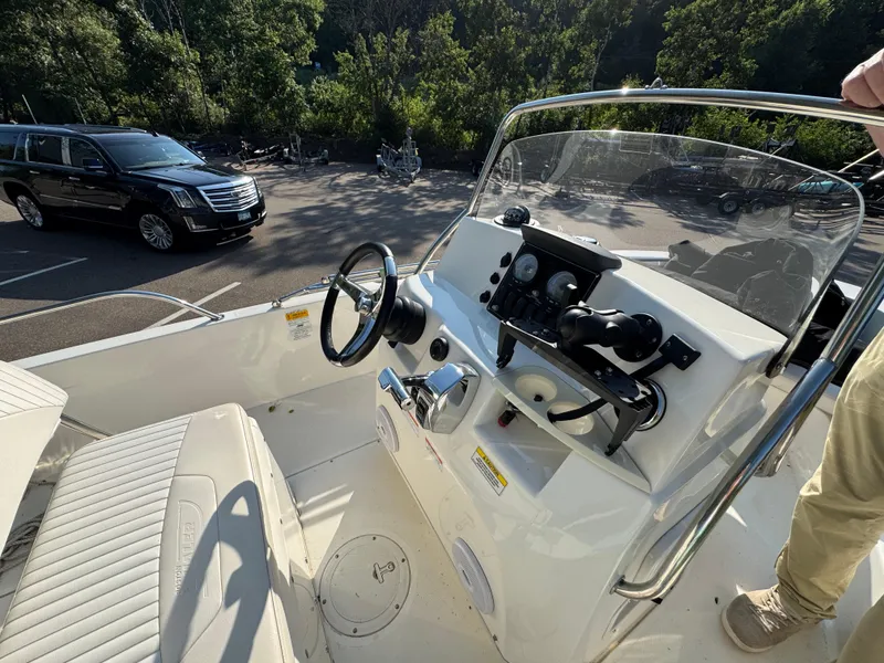 Slide: The Image of 2011 Boston Whaler 180 Dauntless boat interior with steering console and seating. - 9