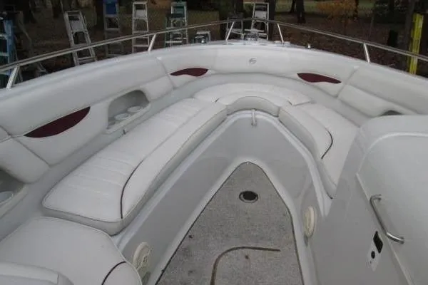 Slide: The Image of 2004 Crownline 288 BR boat interior with white cushioned seating and spacious layout. - 15