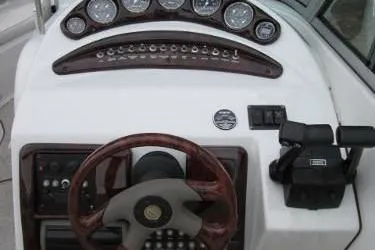 Slide: The Image of 2004 Crownline 288 BR boat dashboard with steering wheel and control panel. - 16