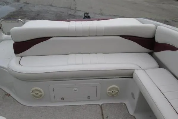 Slide: The Image of 2004 Crownline 288 BR boat interior with white and maroon seating. - 17